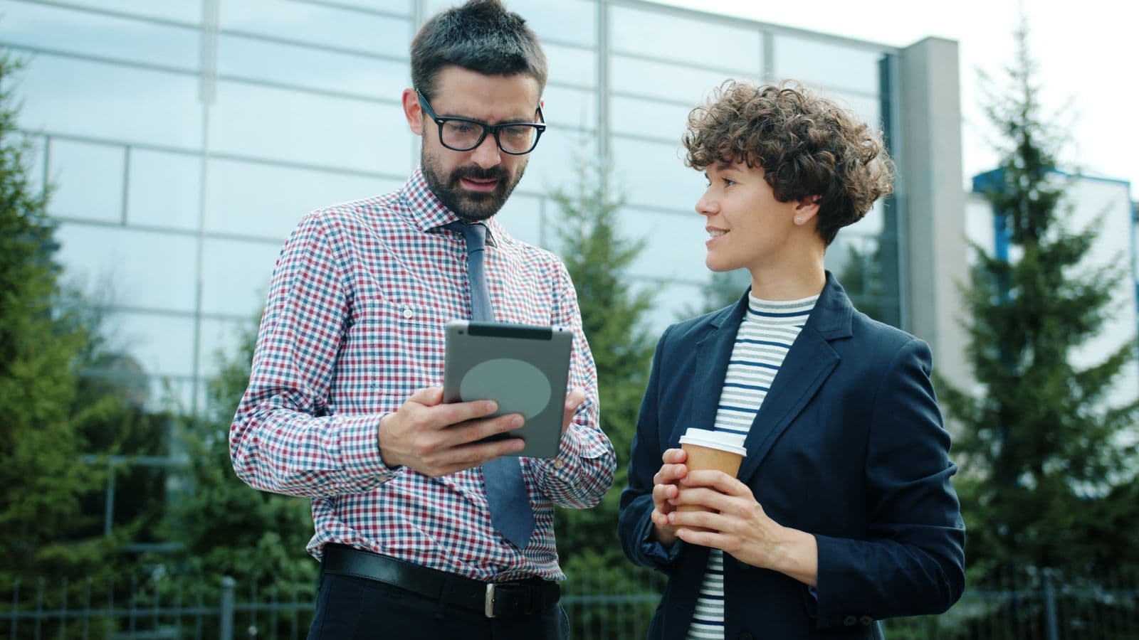 Two professionals reviewing site information on a tablet